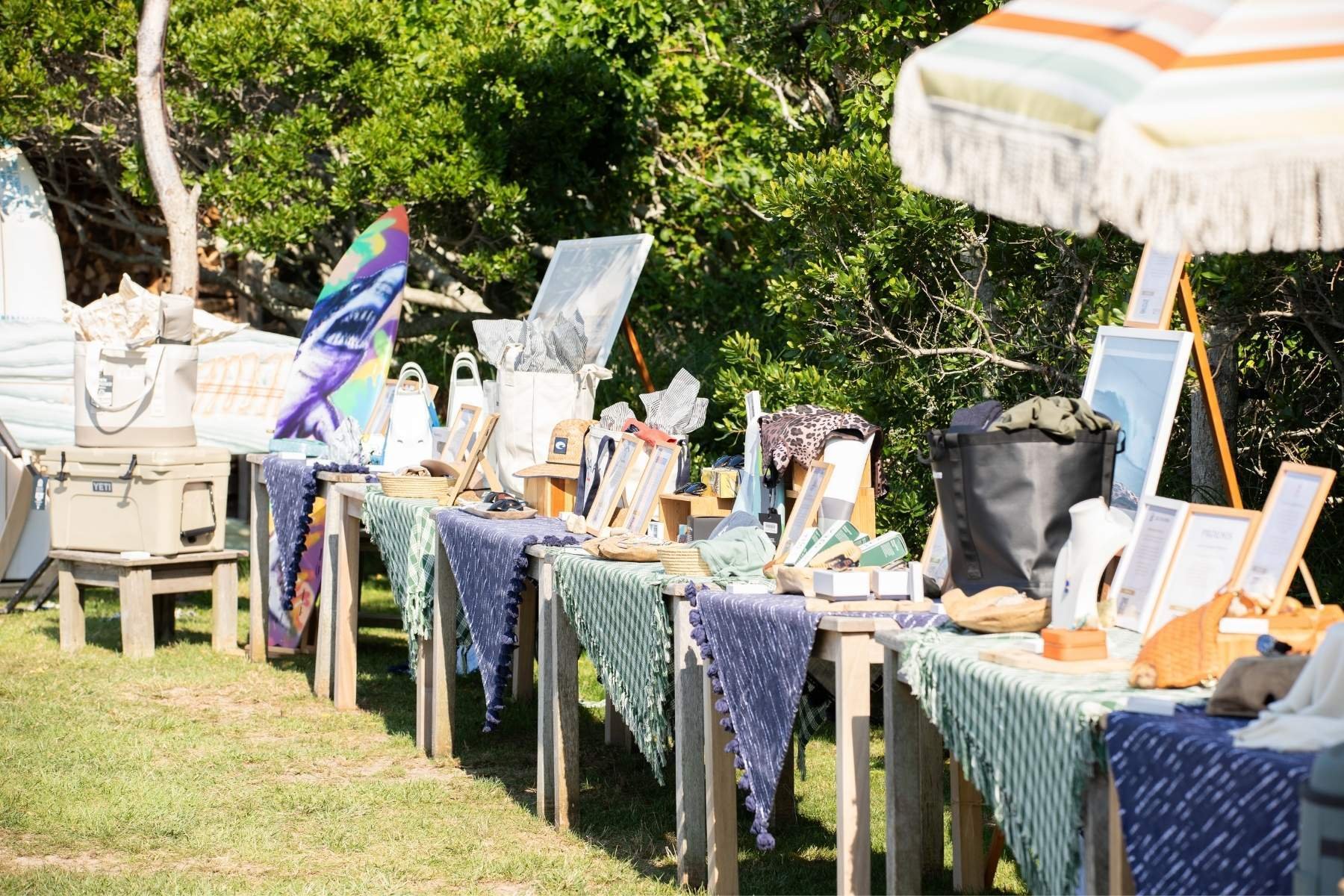 a line of tables with auction items on display.