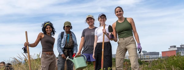 A group of volunteers gather at a dune restoration event.