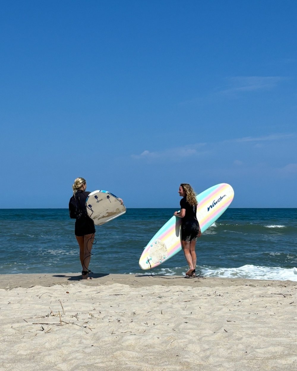 Gracyn and her mom prepare to paddle out.