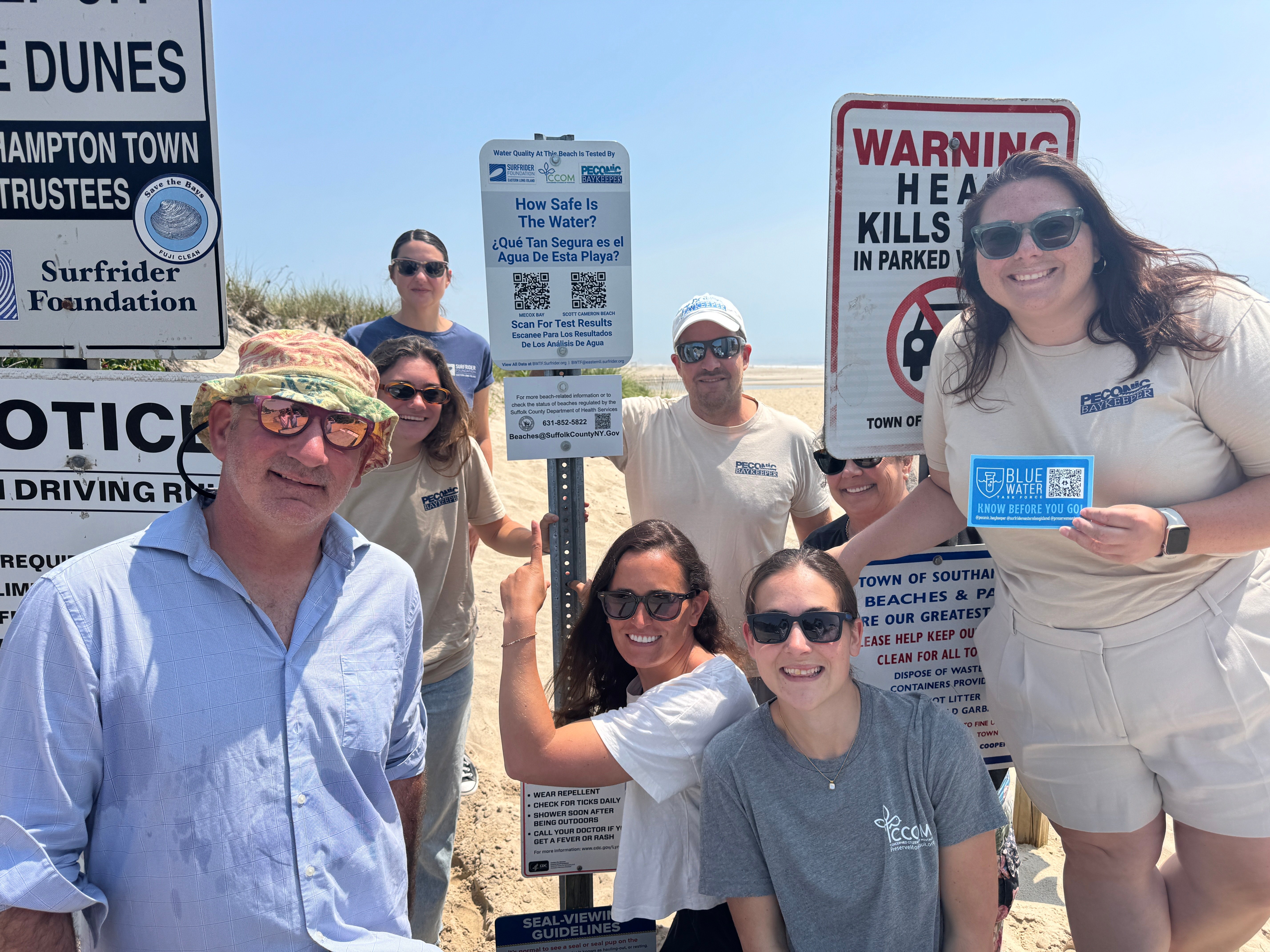 Surfrider, Peconic Baykeeper, CCOM, and Southampton Trustee standing by BWTF Sign. 