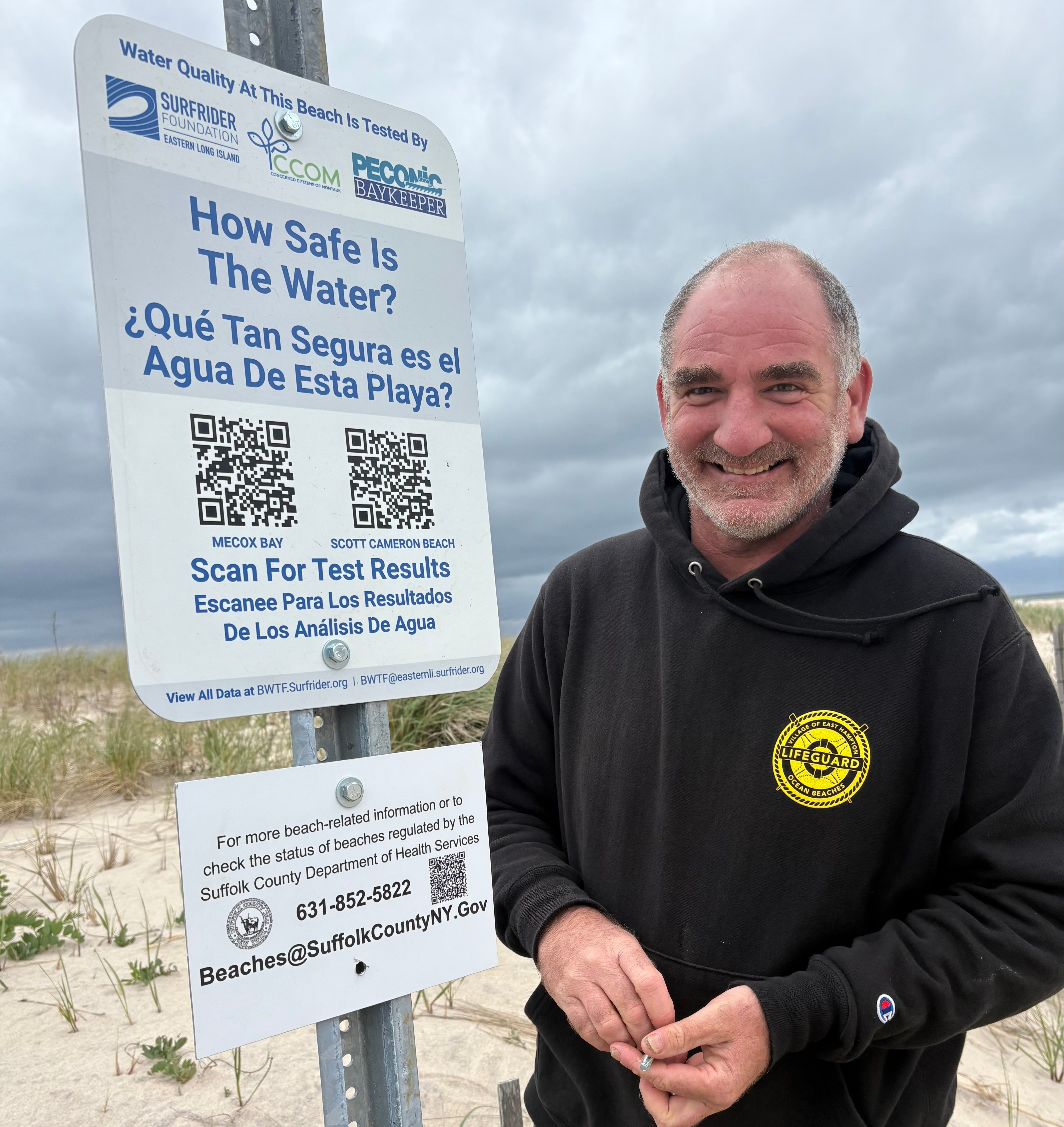 Southampton Town Trustee, Chip Maran, standing beside a BWTF sign.